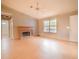 Open-concept living room with hardwood floors, a brick fireplace and a large picture window at 2410 Deep Shoals Cir, Decatur, GA 30034