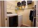 Practical laundry room featuring modern washer and dryer units, storage shelves, and ample space for laundry tasks at 284 Southern Trace Way, Rockmart, GA 30153