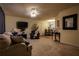 Inviting living room with a cozy sofa, carpet, a ceiling fan, and a TV, and a partial view into the dining area at 284 Southern Trace Way, Rockmart, GA 30153