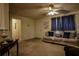 Comfortable living room featuring neutral walls and carpet, a ceiling fan, and a cozy sofa with decorative pillows at 284 Southern Trace Way, Rockmart, GA 30153
