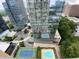 Aerial view of a modern highrise condo building with rooftop pools and tennis court at 3445 Stratford Ne Rd # 2504, Atlanta, GA 30326