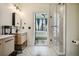 Bright bathroom with double sinks, marble floors, and a glass shower overlooking the bedroom at 3445 Stratford Ne Rd # 2504, Atlanta, GA 30326