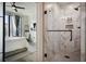 Modern bathroom featuring a glass shower with marble-patterned tile and a glimpse of the bedroom at 3445 Stratford Ne Rd # 2504, Atlanta, GA 30326