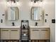 Bright bathroom featuring double vanities, black hardware, and stylish storage shelving at 3445 Stratford Ne Rd # 2504, Atlanta, GA 30326