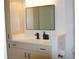 Neutral-toned bathroom vanity with black hardware and a large mirror for a modern aesthetic at 3445 Stratford Ne Rd # 2504, Atlanta, GA 30326