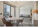 Dining area with floor-to-ceiling window views and an open entryway leading into a cozy living room space at 3445 Stratford Ne Rd # 2504, Atlanta, GA 30326
