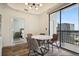 Well-lit dining area with a marble table, view of city, and access to the balcony through sliding glass doors at 3445 Stratford Ne Rd # 2504, Atlanta, GA 30326