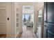 Bright hallway with hardwood floors, shelving, and city views through large windows at 3445 Stratford Ne Rd # 2504, Atlanta, GA 30326
