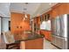 Spacious kitchen with stainless steel refrigerator, dark countertop island, and wood finish cabinets at 3445 Stratford Ne Rd # 2504, Atlanta, GA 30326