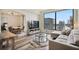 Bright living space featuring a comfortable couch, modern decor, and a stunning city view at 3445 Stratford Ne Rd # 2504, Atlanta, GA 30326