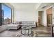 Open-concept living room with hardwood floors, modern furniture, and city views at 3445 Stratford Ne Rd # 2504, Atlanta, GA 30326
