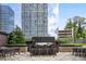 Modern outdoor kitchen with stainless steel grill and bar seating at 3445 Stratford Ne Rd # 2504, Atlanta, GA 30326
