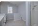 Bright bathroom features tiled floors, a large window and shower with glass door at 4638 Arrow Wind Dr, Powder Springs, GA 30127