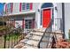 Close-up of the stone staircase leading to a red front door framed by white trim and sidelights at 4638 Arrow Wind Dr, Powder Springs, GA 30127