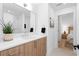 Bright bathroom featuring wood cabinets, modern fixtures, and a large mirror at 567 Ponce De Leon Ne Ave # 404, Atlanta, GA 30308