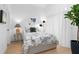 Well-lit bedroom with bright white walls, modern accent lighting and lush houseplant at 567 Ponce De Leon Ave # 404, Atlanta, GA 30308