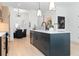 Modern kitchen featuring stainless steel appliances, a large island, and stylish lighting fixtures at 567 Ponce De Leon Ne Ave # 404, Atlanta, GA 30308