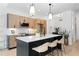 This modern kitchen features wood cabinets, an island with seating, and stylish pendant lighting at 567 Ponce De Leon Ave # 404, Atlanta, GA 30308