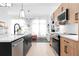 Modern kitchen featuring black and wood cabinets, stainless steel appliances, and a stylish island at 567 Ponce De Leon Ne Ave # 404, Atlanta, GA 30308