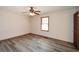 This bedroom features gray vinyl flooring, a ceiling fan, and trim around the window and floor at 4800 Timber Ridge Dr, Douglasville, GA 30135