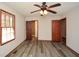 This bedroom features gray vinyl flooring, a ceiling fan, and wood doors to a closet at 4800 Timber Ridge Dr, Douglasville, GA 30135