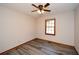 This bedroom features gray vinyl flooring, a ceiling fan, and trim around the window and floor at 4800 Timber Ridge Dr, Douglasville, GA 30135