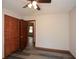 This bedroom features gray vinyl flooring and a dark-stained wood, louvered door for the closet at 4800 Timber Ridge Dr, Douglasville, GA 30135