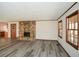 Spacious living room featuring a stone fireplace, gray wood floors, and natural light at 4800 Timber Ridge Dr, Douglasville, GA 30135