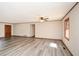 Bright living room featuring modern gray floors, ceiling fan and natural light from a large window at 4800 Timber Ridge Dr, Douglasville, GA 30135