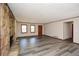 Spacious living room with stone fireplace, stylish gray flooring, and ample natural lighting at 4800 Timber Ridge Dr, Douglasville, GA 30135