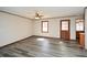 Open living space with ceiling fan, gray floors, and natural light from a large window at 4800 Timber Ridge Dr, Douglasville, GA 30135