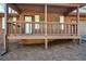 Close-up of front porch showing wood rails, support beams, white trim, and the front door at 4800 Timber Ridge Dr, Douglasville, GA 30135