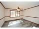 This room has great natural light from a big window, ceiling fan, gray floors and neutral colors at 4800 Timber Ridge Dr, Douglasville, GA 30135