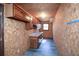 Room with wood-paneled walls and cabinets, featuring a countertop and window at 4800 Timber Ridge Dr, Douglasville, GA 30135