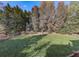Large backyard with mature trees and a charming wooden fence at 1009 Fairway Seven, Villa Rica, GA 30180