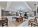 Open basement layout featuring a pool table, bar seating, and natural light, creating a versatile space at 1009 Fairway Seven, Villa Rica, GA 30180