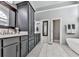 Modern bathroom features a soaking tub, dual sinks, and gray cabinetry at 1009 Fairway Seven, Villa Rica, GA 30180