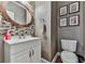 Bathroom with a tiled backsplash, white vanity, and wood-framed mirror at 1009 Fairway Seven, Villa Rica, GA 30180