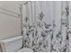 Bathroom with floral patterned shower curtain and simple toilet at 1009 Fairway Seven, Villa Rica, GA 30180