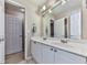 Bright bathroom featuring dual sink vanity with large mirror and white cabinets at 1009 Fairway Seven, Villa Rica, GA 30180