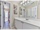 Bathroom features a white vanity with a large mirror, framed art, and tile flooring at 1009 Fairway Seven, Villa Rica, GA 30180