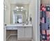 Bathroom featuring white vanity and tile floors with a glimpse into the adjoining room at 1009 Fairway Seven, Villa Rica, GA 30180