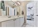 Bathroom featuring double sink vanity with large mirror and a glimpse into the nearby bedroom at 1009 Fairway Seven, Villa Rica, GA 30180