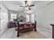 Bedroom with wrought iron bed frame, light carpet and fan at 1009 Fairway Seven, Villa Rica, GA 30180