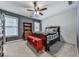 Cozy bedroom with a patriotic quilt, wooden furniture, ceiling fan, and lots of light from two large windows at 1009 Fairway Seven, Villa Rica, GA 30180