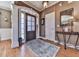 Inviting entryway with hardwood floors, a decorative rug, and a dark wood door with glass panels at 1009 Fairway Seven, Villa Rica, GA 30180