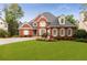 Lovely two-story brick home with manicured lawn and beautiful flower beds in a desirable neighborhood at 1009 Fairway Seven, Villa Rica, GA 30180