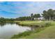 Scenic view of the lush golf course, enhanced by tranquil lake at 1009 Fairway Seven, Villa Rica, GA 30180