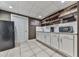 Basement kitchenette featuring white cabinets, modern appliances, and open shelving with rustic wood accents at 1009 Fairway Seven, Villa Rica, GA 30180