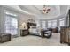 Spacious main bedroom featuring tray ceilings, carpet, and multiple windows at 1009 Fairway Seven, Villa Rica, GA 30180